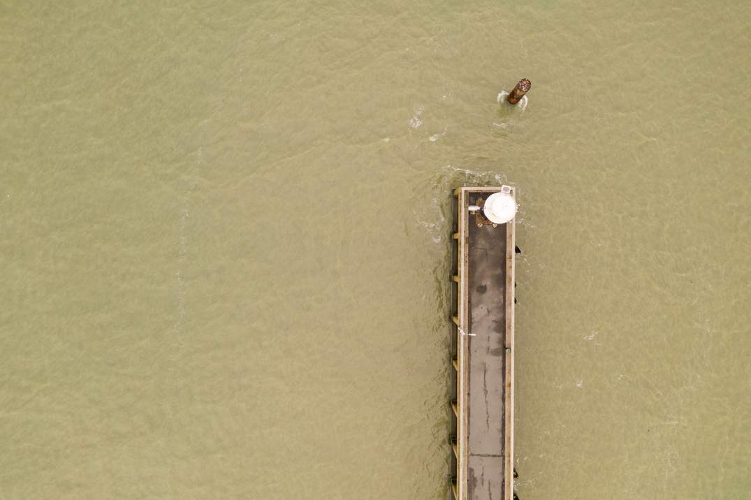 Aerial View of Dock on Beige Body of Water